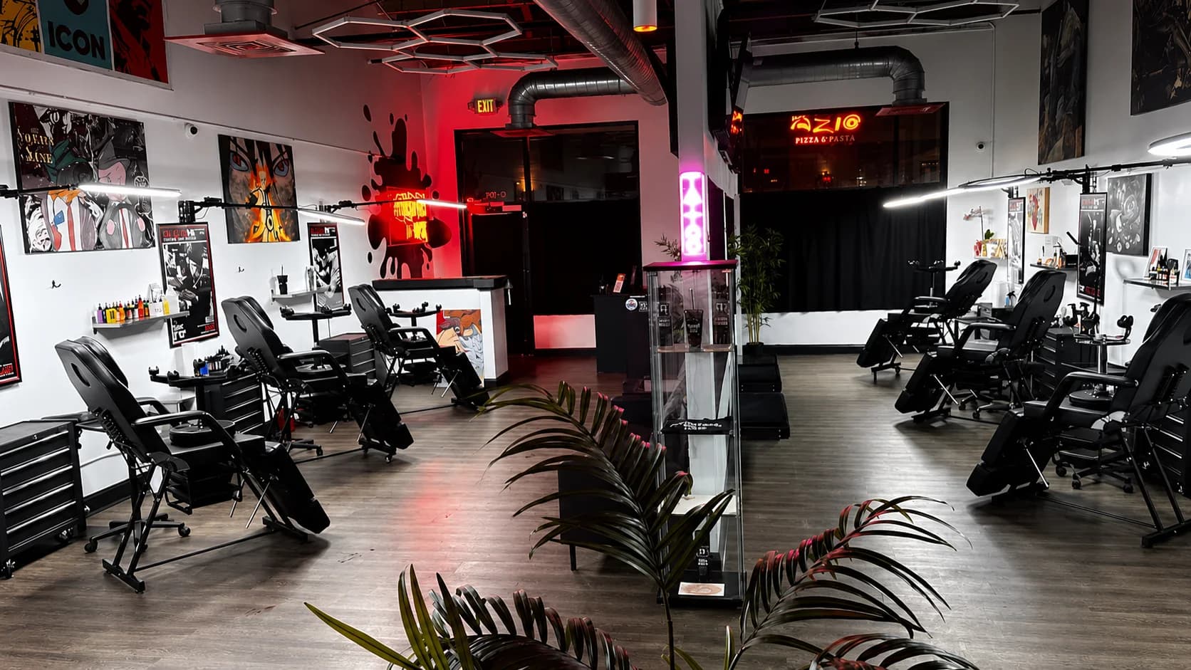 Tattoo chairs along the ATLANTA INK studio floor under red light
